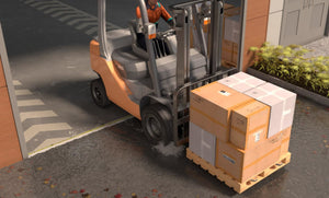 CGI render of a forklift moving a pallet out of a clean warehouse with an installed half inch commercial door threshold seal