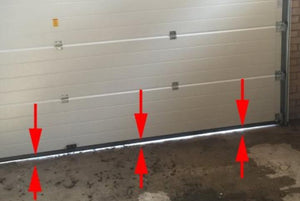 Arrows pointing to the gap between the floor and garage door, showing customers how to measure the height of the gap