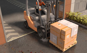 Forklift carrying out boxes out of a clean warehouse protected by 1" commercial door aluminum threshold seal